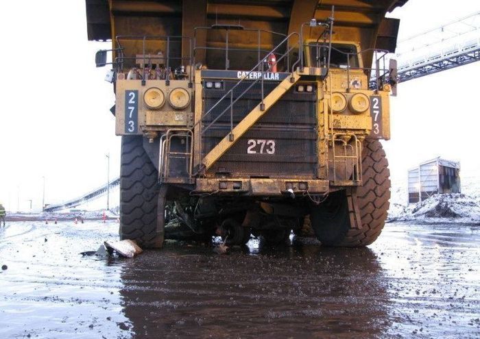Caterpillar truck easily transforms ordinary vehicle into a pile of scrap metal - 01