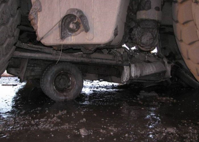 Caterpillar truck easily transforms ordinary vehicle into a pile of scrap metal - 04