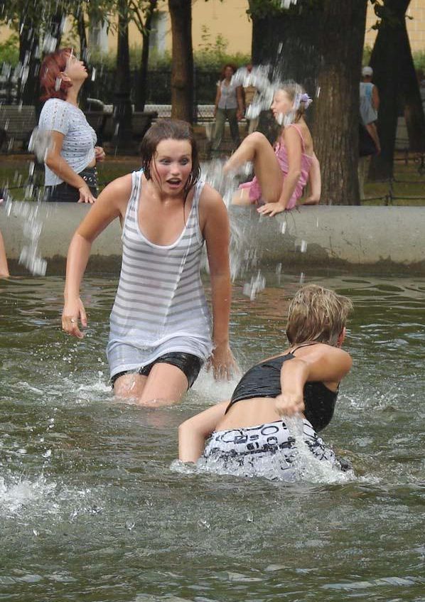 Amusing girls having fun in the fountains - 01