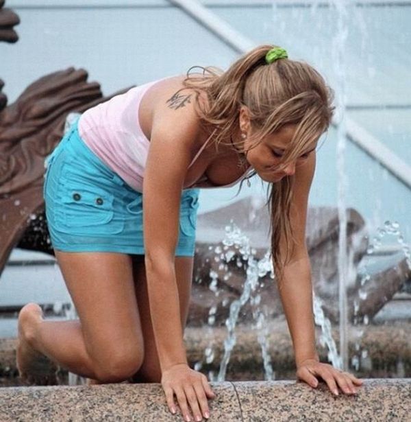 Amusing girls having fun in the fountains - 04