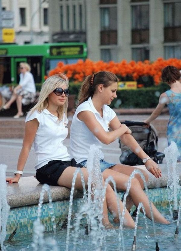Amusing girls having fun in the fountains - 11