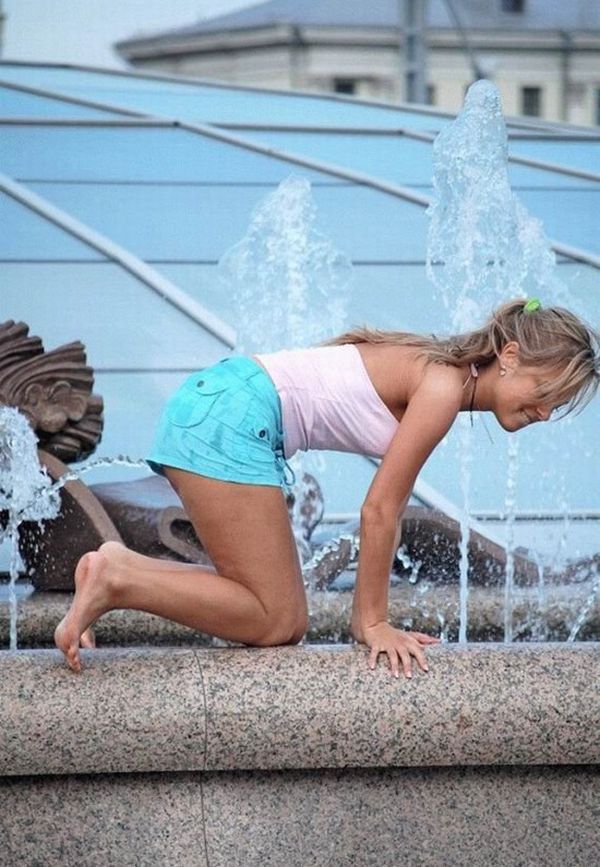 Amusing girls having fun in the fountains - 12