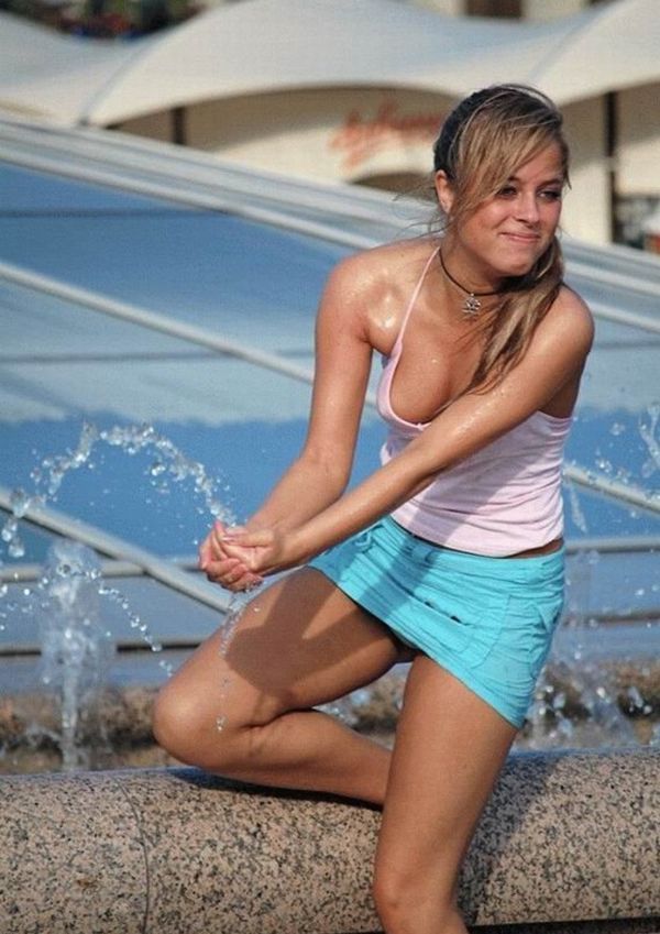 Amusing girls having fun in the fountains - 16