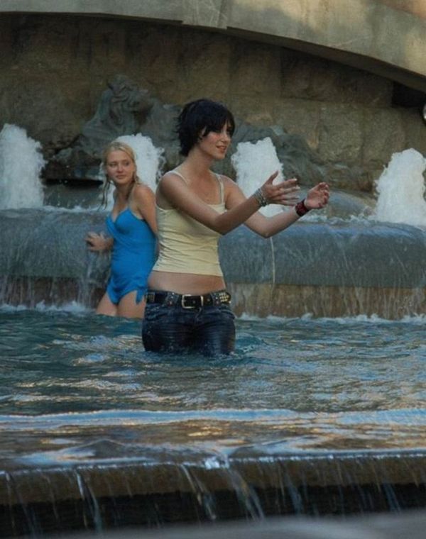 Amusing girls having fun in the fountains - 17