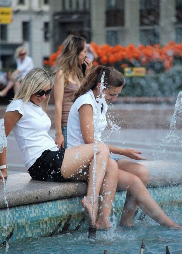 Amusing girls having fun in the fountains - 25